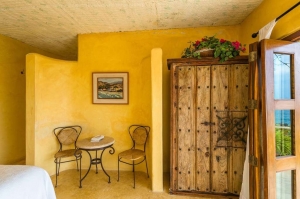 amor-boutique-hotel-la-paz-mexico-sitting-area-wood-armoir